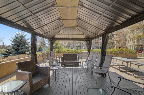 Expansive outdoor gazebo with a solid roof and privacy curtains - 204 278 Suder Greens Drive, Edmonton, AB - Outdoor With Deck Patio Veranda With Exterior