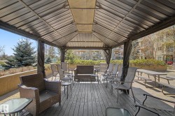 Expansive outdoor gazebo with a solid roof and privacy curtains - 