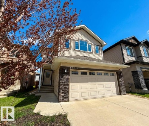 Two-story residence featuring light-colored siding and a two-car garage - 4875 Wright Drive, Edmonton, AB - Outdoor With Facade