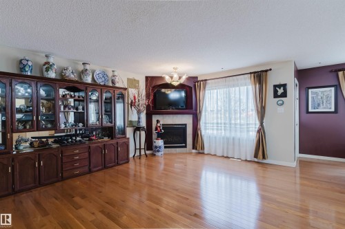 Warm wood-finish flooring throughout the room - 1764 Melrose Crescent, Edmonton, AB 