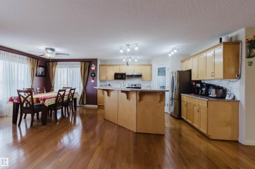 Open-concept living space with lustrous wood-finish flooring - 1764 Melrose Crescent, Edmonton, AB 