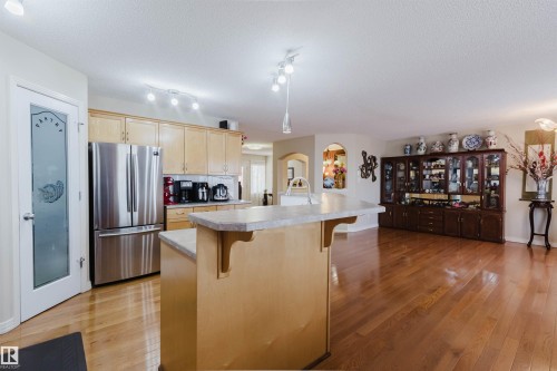 Kitchen featuring light wood cabinetry and a stainless steel refrigerator - 1764 Melrose Crescent, Edmonton, AB 