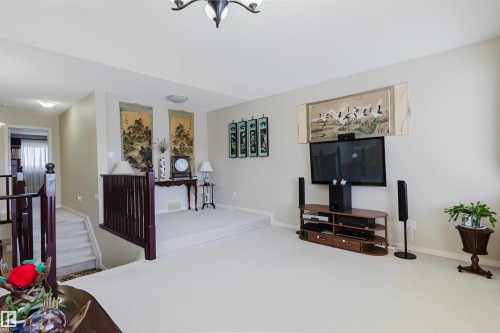 Carpeted living space with neutral wall tones and a built-in recessed ceiling light fixture - 1764 Melrose Crescent, Edmonton, AB 