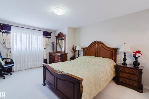 Carpeted room with a large window, featuring a ceiling-mounted light fixture - 1764 Melrose Crescent, Edmonton, AB 