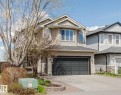 Contemporary two-story residence featuring light beige siding and a dark shingle roof - 1764 Melrose Crescent, Edmonton, AB 