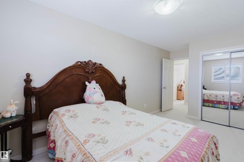 Spacious bedroom featuring light-colored walls and carpet flooring - 1764 Melrose Crescent, Edmonton, AB 