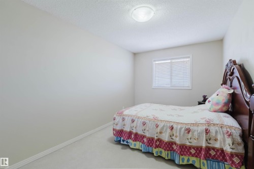 Light-colored walls with white trim, a single window featuring blinds, and a built-in ceiling light fixture - 1764 Melrose Crescent, Edmonton, AB 