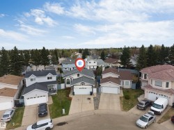 Single-family residence with a two-car garage and a paved driveway - 