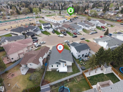 Property situated on a cul-de-sac with a fenced backyard featuring a deck, fire pit, and mature trees - 1529 49A Street Nw, Edmonton, AB - Outdoor With View