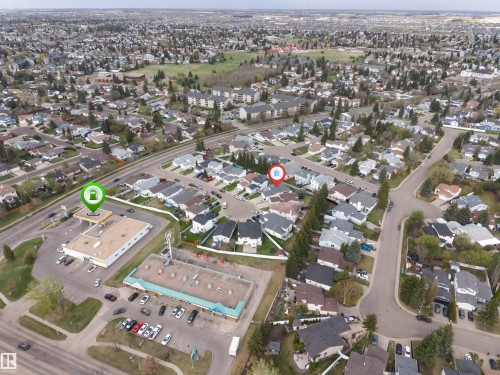 Aerial perspective of a residential neighborhood with a mix of single-family homes and multi-story buildings, featuring mature trees and green spaces - 1529 49A Street Nw, Edmonton, AB -  With View
