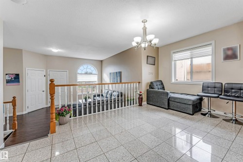 Spacious interior featuring large format tile flooring and neutral wall tones - 1529 49A Street Nw, Edmonton, AB - Indoor Photo Showing Other Room