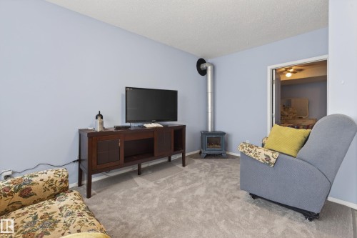 Light blue walls complement the gray carpeting in this interior space - 21 Pipestone Drive, Devon, AB - Indoor