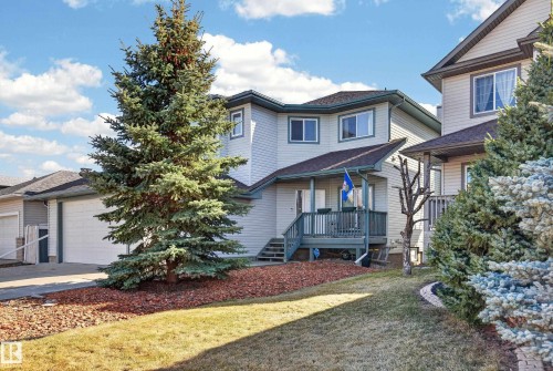 Multi-level home featuring light-toned siding and a dark shingle roof - 21 Pipestone Drive, Devon, AB - Outdoor With Deck Patio Veranda With Facade