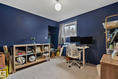 Room featuring blue painted walls and light-toned carpeting - 4707 10A Avenue, Edmonton, AB 