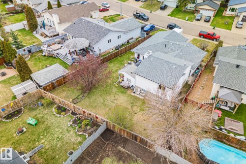 Expansive backyard featuring a multi-level deck, gazebo, detached shed, wood privacy fencing, and mature trees - 4707 10A Avenue, Edmonton, AB 