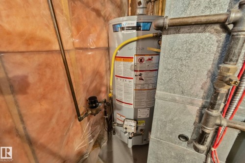 Water heater with associated piping and visible insulation - 4707 10A Avenue, Edmonton, AB 