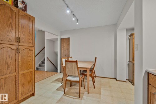 Dining area featuring light-toned flooring, white walls, and track lighting - 4707 10A Avenue, Edmonton, AB 