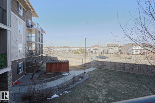 Multi-story building exterior with individual balconies featuring black metal railings - 201 1520 Hammond Gate Gate, Edmonton, AB 