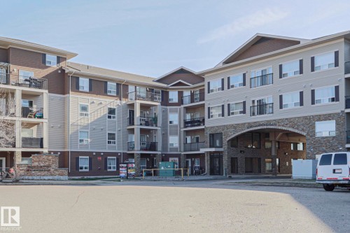 Multi-story residential building featuring stone accents and light-colored siding - 201 1520 Hammond Gate Gate, Edmonton, AB 