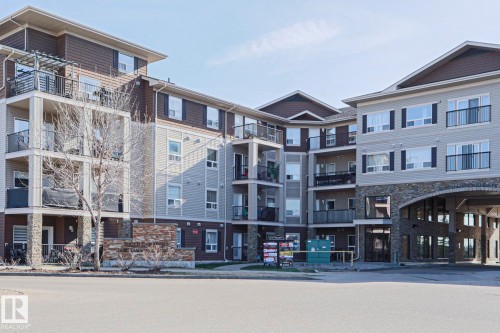 Multi-story residential building featuring diverse facade materials including horizontal siding, shingle siding, and stone accents - 201 1520 Hammond Gate Gate, Edmonton, AB 