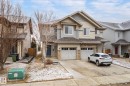Two-story residence featuring a combination of siding and stone veneer on the facade - 1668 Chapman Way Sw, Edmonton, AB  - Outdoor With Facade 