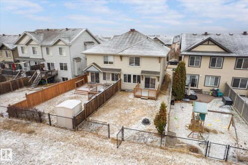 Rear exterior with a wood deck, sliding glass door access, and a fully fenced backyard - 1668 Chapman Way Sw, Edmonton, AB - Outdoor