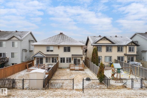 Spacious backyard featuring a chain-link fence, a wooden privacy fence, and a wooden deck - 1668 Chapman Way Sw, Edmonton, AB - Outdoor