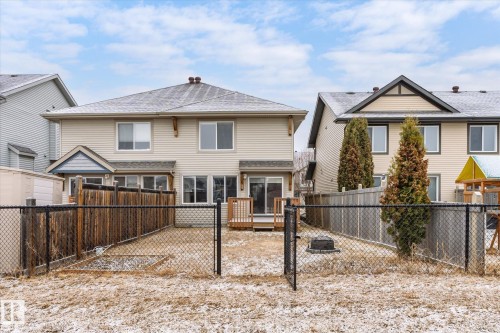 Rear exterior featuring neutral-toned siding and a shingled roof - 1668 Chapman Way Sw, Edmonton, AB - Outdoor