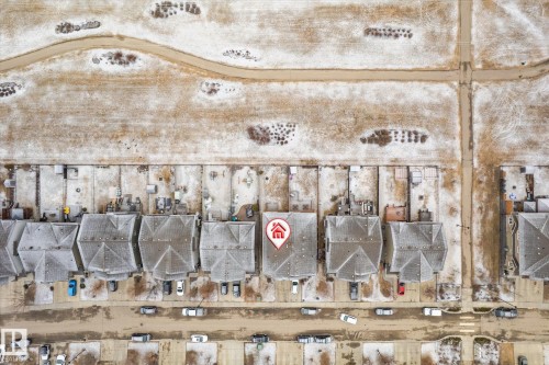 Aerial perspective showcasing a residential street with multiple properties, marked by a central property - 1668 Chapman Way Sw, Edmonton, AB - 