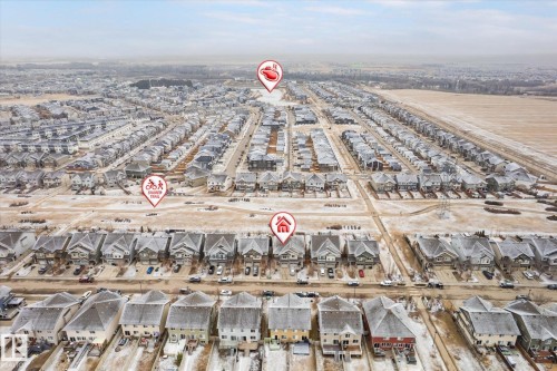 Aerial perspective of a developed residential subdivision featuring numerous detached homes with varying architectural styles - 1668 Chapman Way Sw, Edmonton, AB - Outdoor With View
