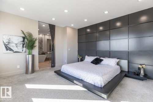 Huge Primary Bedroom featuring Private Sitting room with Wet Bar and Bar Fridge, Huge Ensuite Closet, Three Sided Fireplace, and Ensuite - 5536 Chegwin Point(E), Edmonton, AB - Indoor Photo Showing Bedroom