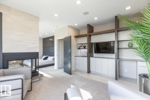 Huge Primary Bedroom featuring Private Sitting room with Wet Bar and Bar Fridge, Huge Ensuite Closet, Three Sided Fireplace, and Ensuite - 5536 Chegwin Point(E), Edmonton, AB - Indoor