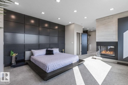 Huge Primary Bedroom featuring Private Sitting room with Wet Bar and Bar Fridge, Huge Ensuite Closet, Three Sided Fireplace, and Ensuite - 5536 Chegwin Point(E), Edmonton, AB - Indoor With Fireplace