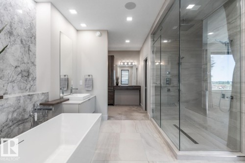 Primary 5 Piece Ensuite Bathroom featuring Glass Shower, Standalone Tub, Heated Floors, and Pass Through to Walk in Closet - 5536 Chegwin Point(E), Edmonton, AB - Indoor Photo Showing Bathroom