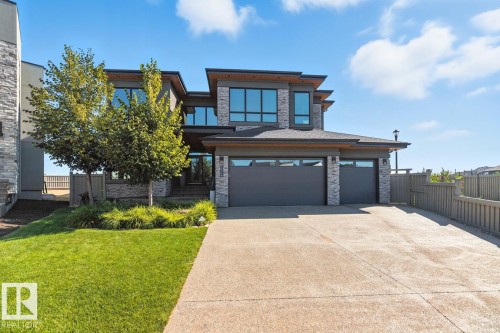 Exterior Front of House showing Oversized Driveway, Triple Car Garage, and Siding on to Walking Path - 5536 Chegwin Point(E), Edmonton, AB - Outdoor