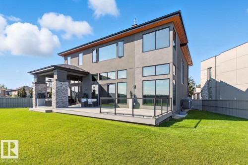 North East Facing Back yard featuring Covered Deck with Composite Boards, Ample Grass Space, Pickle Ball/Basketball Court, Fully Landscaped, and Fully Fenced. - 5536 Chegwin Point(E), Edmonton, AB - Outdoor