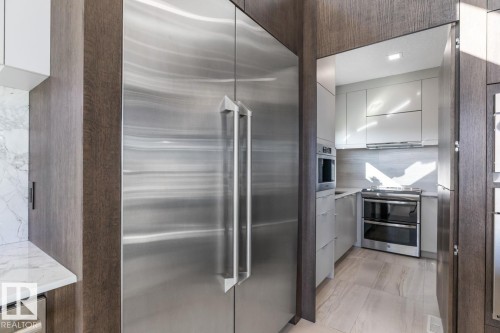 Stunning Kitchen featuring floor to ceiling windows with remote blinds, Gas Stove Top, Pizza Oven, Microwave Convection Oven, Oversized Refrigerator, Granite Counters, and Two Tone Cabinets. - 5536 Chegwin Point(E), Edmonton, AB - Indoor Photo Showing Kitchen With Upgraded Kitchen