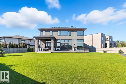 North East Facing Back yard featuring Covered Deck with Composite Boards, Ample Grass Space, Pickle Ball/Basketball Court, Fully Landscaped, and Fully Fenced. - 5536 Chegwin Point(E), Edmonton, AB - Outdoor