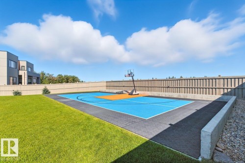 North East Facing Back yard featuring Covered Deck with Composite Boards, Ample Grass Space, Pickle Ball/Basketball Court, Fully Landscaped, and Fully Fenced. - 5536 Chegwin Point(E), Edmonton, AB - Outdoor With In Ground Pool