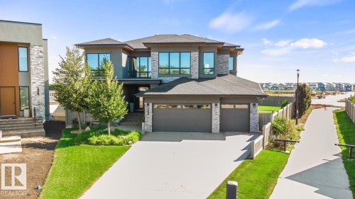Exterior Front of House showing Oversized Driveway, Triple Car Garage, and Siding on to Walking Path - 5536 Chegwin Point(E), Edmonton, AB - Outdoor