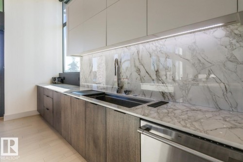 Stunning Kitchen featuring floor to ceiling windows with remote blinds, Gas Stove Top, Pizza Oven, Microwave Convection Oven, Oversized Refrigerator, Granite Counters, and Two Tone Cabinets. - 5536 Chegwin Point(E), Edmonton, AB - Indoor Photo Showing Kitchen