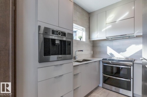 Spice Kitchen located just off the Main Kitchen featuring a Built in Bosch Coffee Machine, Gas Stove, and Ample Storage - 5536 Chegwin Point(E), Edmonton, AB - Indoor Photo Showing Kitchen With Double Sink