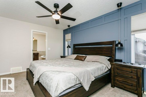 Bedroom featuring a decorative accent wall with paneling, recessed lighting, and a ceiling fan - 42 Santana Crescent, Fort Saskatchewan, AB - Indoor Photo Showing Bedroom