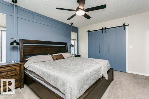 Textured ceiling with a central ceiling fan - 42 Santana Crescent, Fort Saskatchewan, AB - Indoor Photo Showing Bedroom