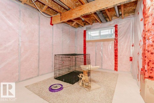 Unfinished basement space featuring visible insulation, exposed wooden ceiling joists, a window, and concrete flooring - 42 Santana Crescent, Fort Saskatchewan, AB - Indoor Photo Showing Basement