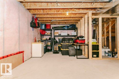 Unfinished basement featuring exposed wood framing, concrete flooring, and partial wall insulation - 42 Santana Crescent, Fort Saskatchewan, AB - Indoor