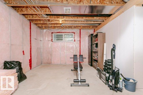 Unfinished basement space featuring exposed wood joists, a concrete floor, and insulation-wrapped walls - 42 Santana Crescent, Fort Saskatchewan, AB - Indoor Photo Showing Basement