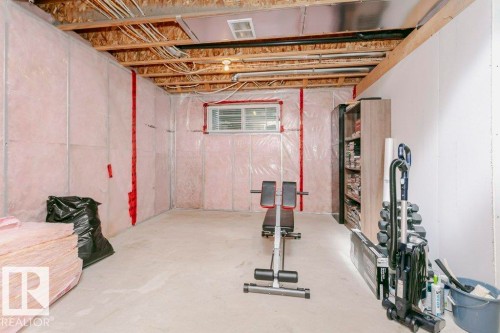 Unfinished basement space featuring exposed ceiling joists, insulated walls, concrete flooring, and a single window - 42 Santana Crescent, Fort Saskatchewan, AB - Indoor Photo Showing Basement