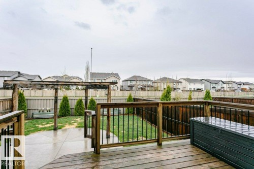 Spacious outdoor deck with natural wood planks and black metal balusters - 42 Santana Crescent, Fort Saskatchewan, AB - Outdoor With Deck Patio Veranda