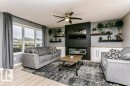 Living area featuring light wood-finish flooring and a contemporary ceiling fan - 42 Santana Crescent, Fort Saskatchewan, AB  - Indoor Photo Showing Living Room 